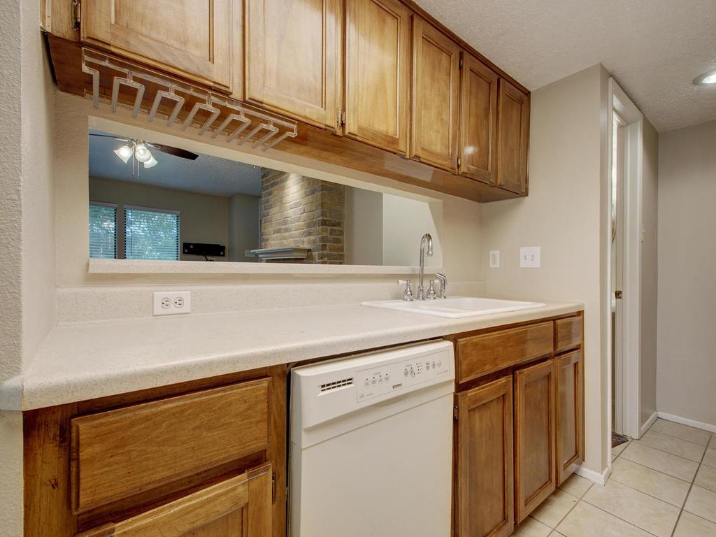 11301 Jollyville Road, Unit A3 Austin, TX 78759 - Photo 15 of 26 a kitchen with stainless steel appliances granite countertop a sink and cabinets