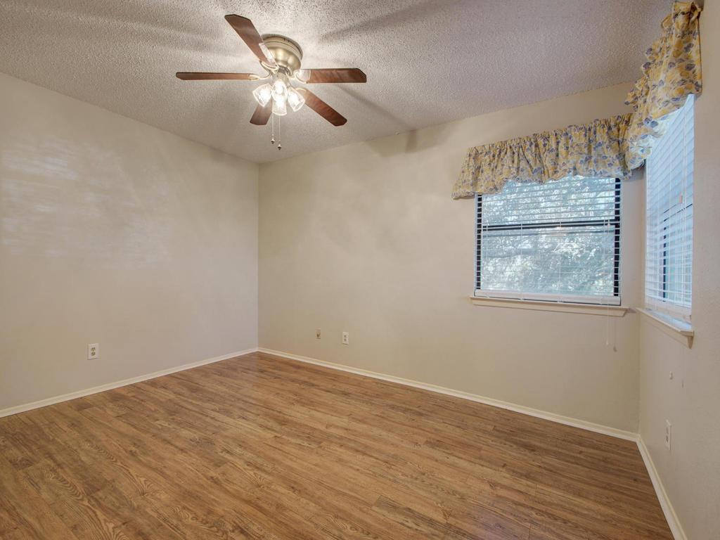11301 Jollyville Road, Unit A3 Austin, TX 78759 - Photo 17 of 26 a view of an empty room with a window and a fan