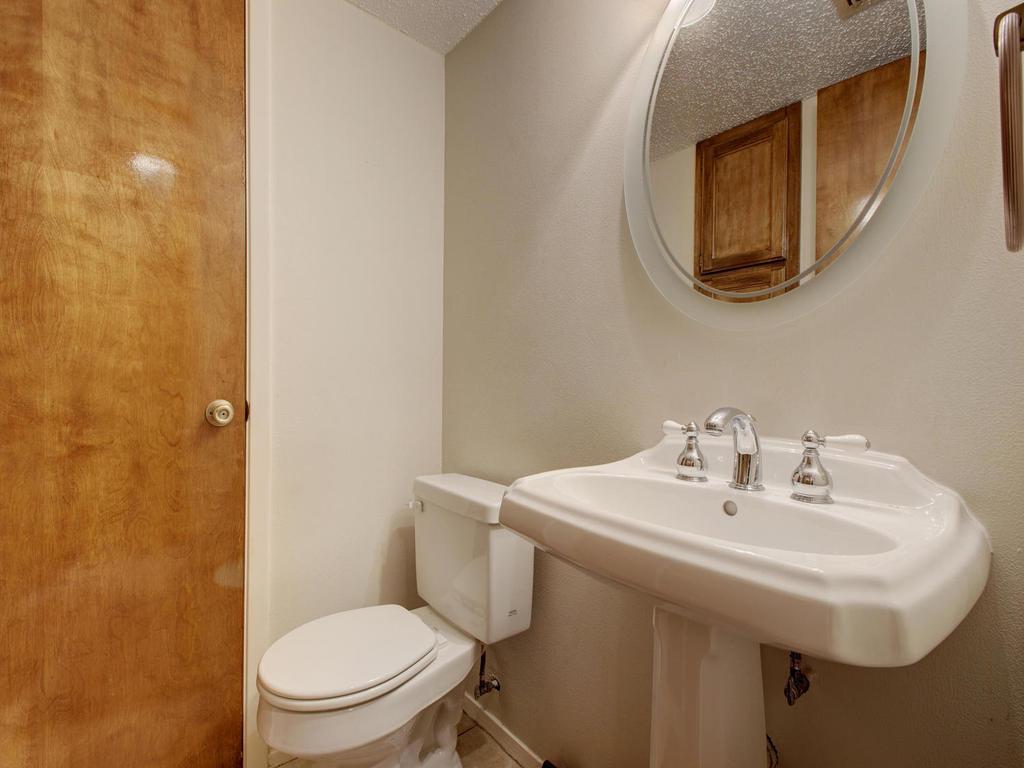11301 Jollyville Road, Unit A3 Austin, TX 78759 - Photo 22 of 26 a bathroom with a toilet a sink and mirror