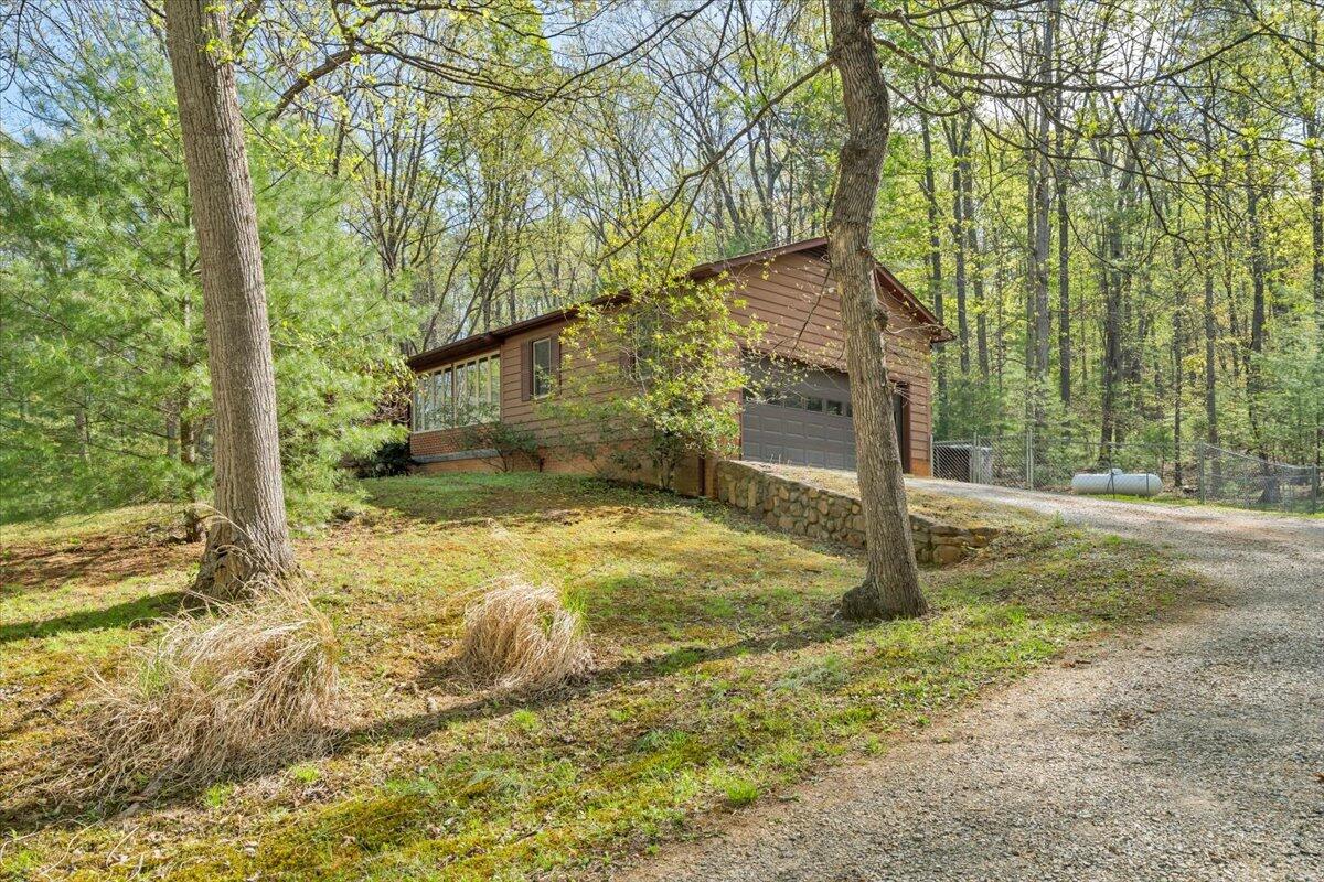 3878 Harborwood Road Salem, VA 24153 - Photo 2 of 60 a backyard of a house with large trees and wooden fence