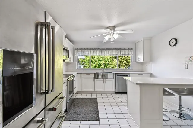 a kitchen with appliances cabinets and a sink