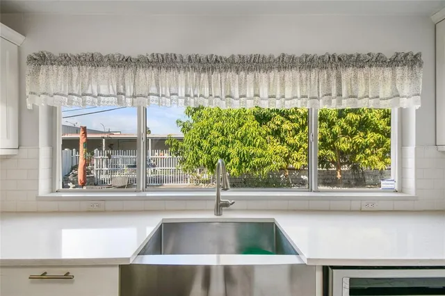 a kitchen with a sink stainless steel appliances and cabinets