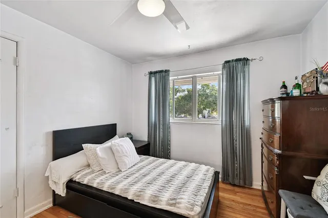 a bedroom with furniture and wooden floor