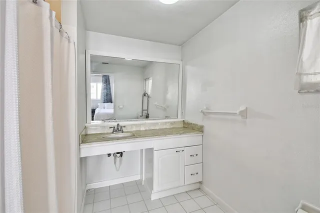 a bathroom with a granite countertop sink mirror and double