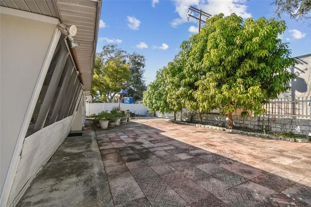 a view of a patio with table and chairs with wooden fence