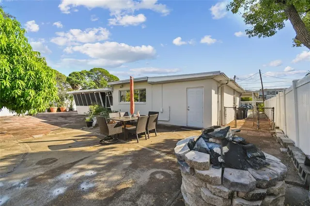 a view of a patio with table and chairs and potted plants