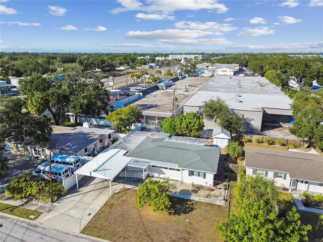 an aerial view of residential houses with outdoor space and swimming pool
