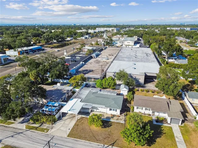 an aerial view of residential houses with outdoor space
