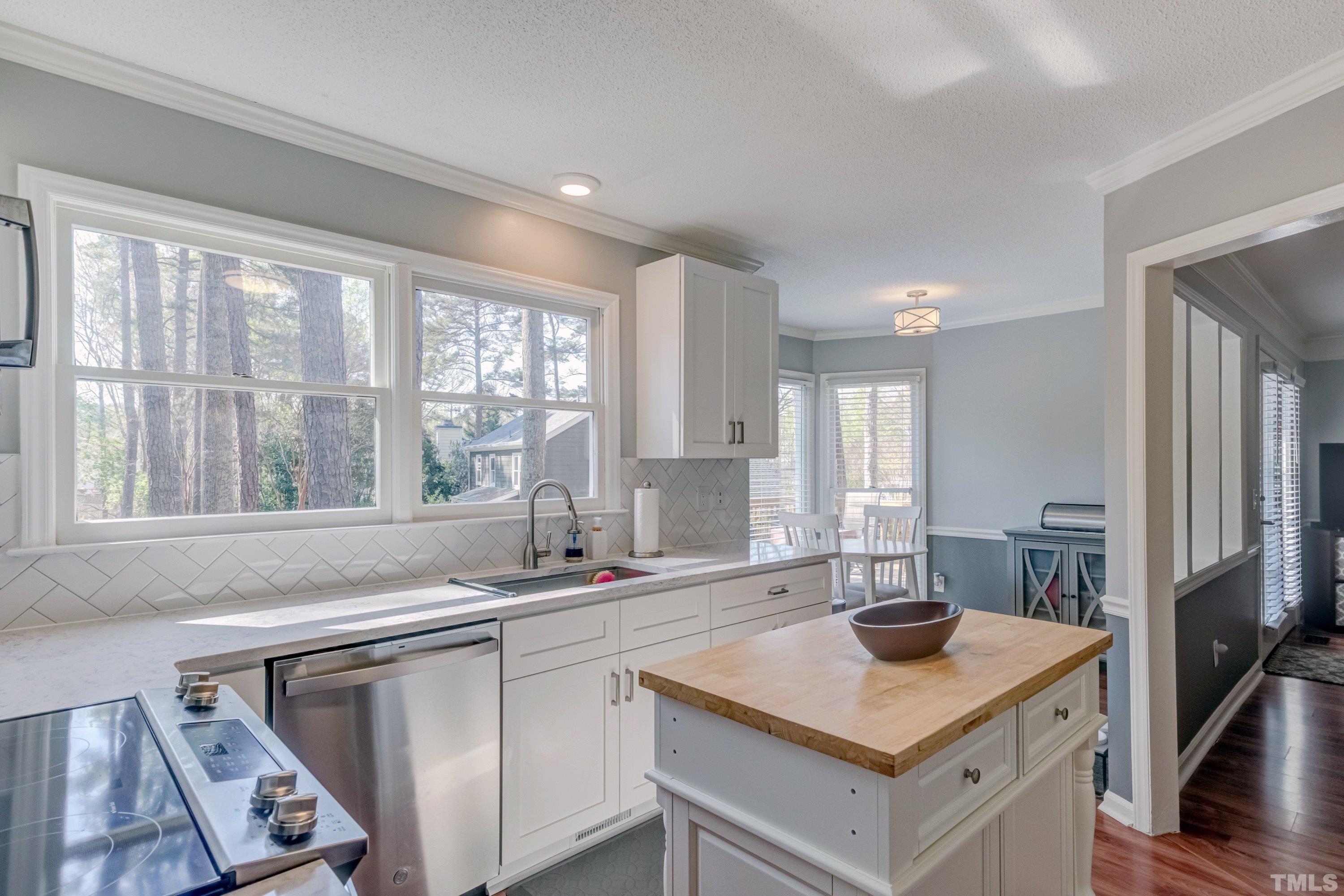 105 McIntire Lane Cary, NC 27513 - Photo 13 of 32 a kitchen with a sink stove and cabinets