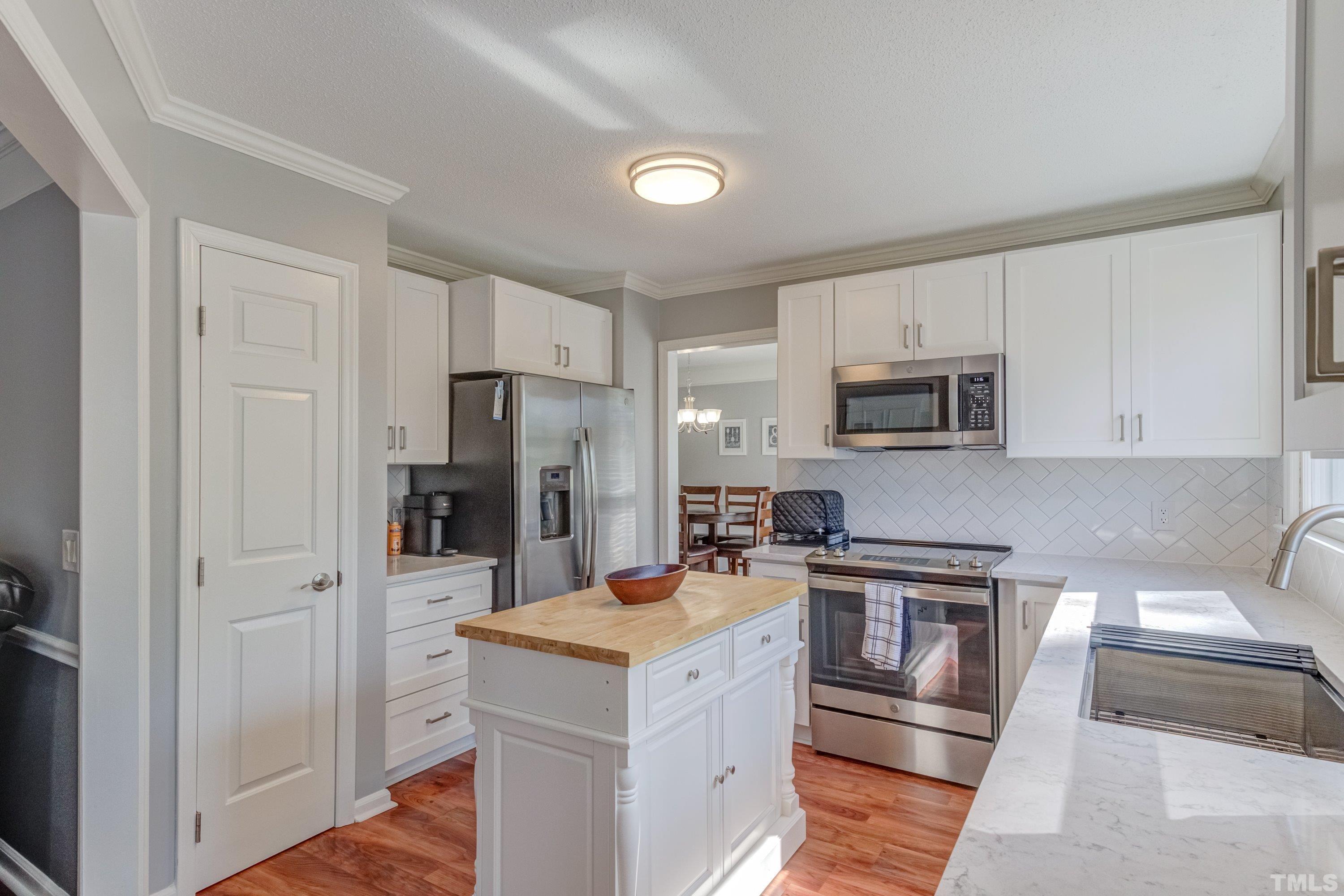 105 McIntire Lane Cary, NC 27513 - Photo 15 of 32 a kitchen with a refrigerator stove and microwave