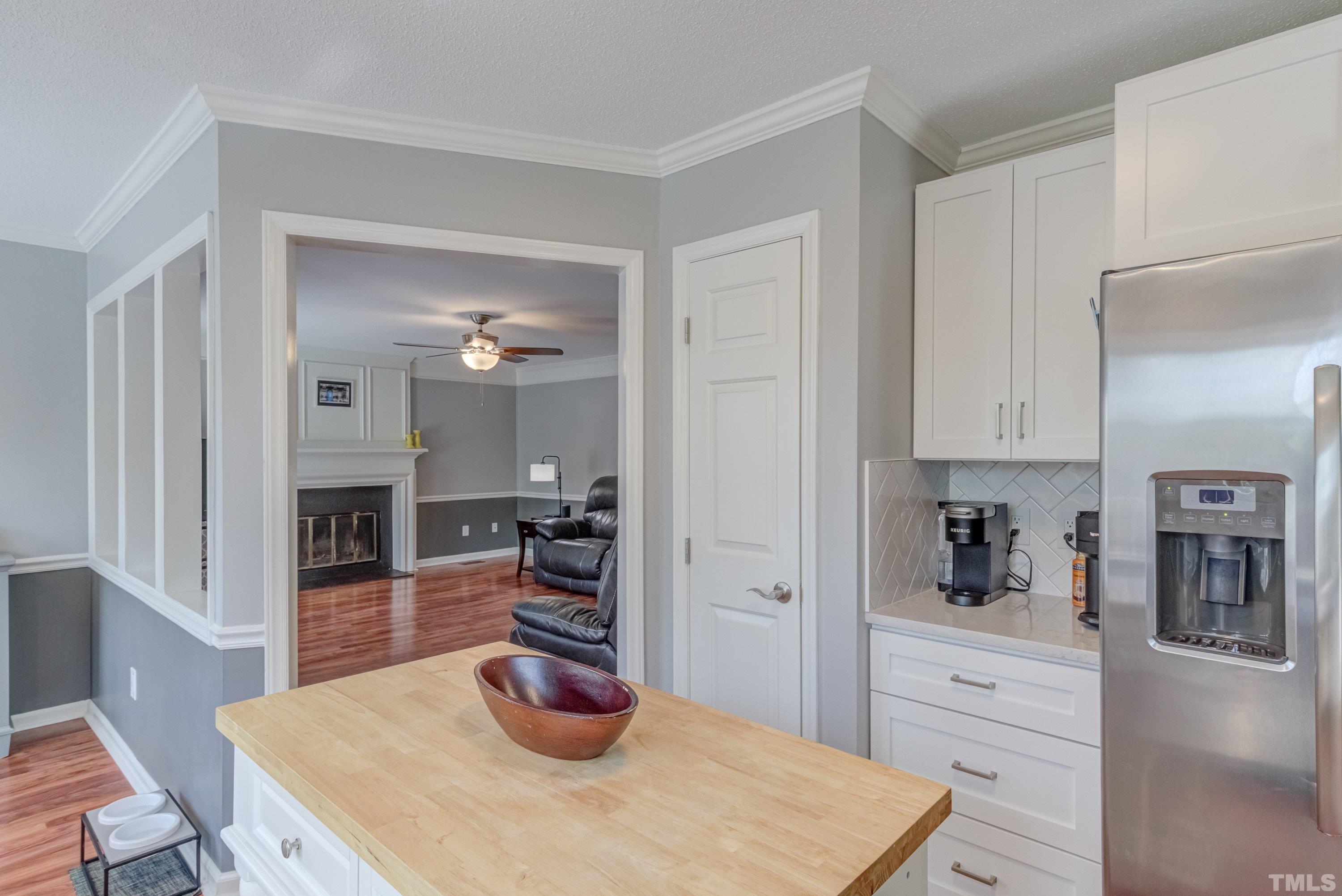 105 McIntire Lane Cary, NC 27513 - Photo 16 of 32 a kitchen with a refrigerator and cabinets