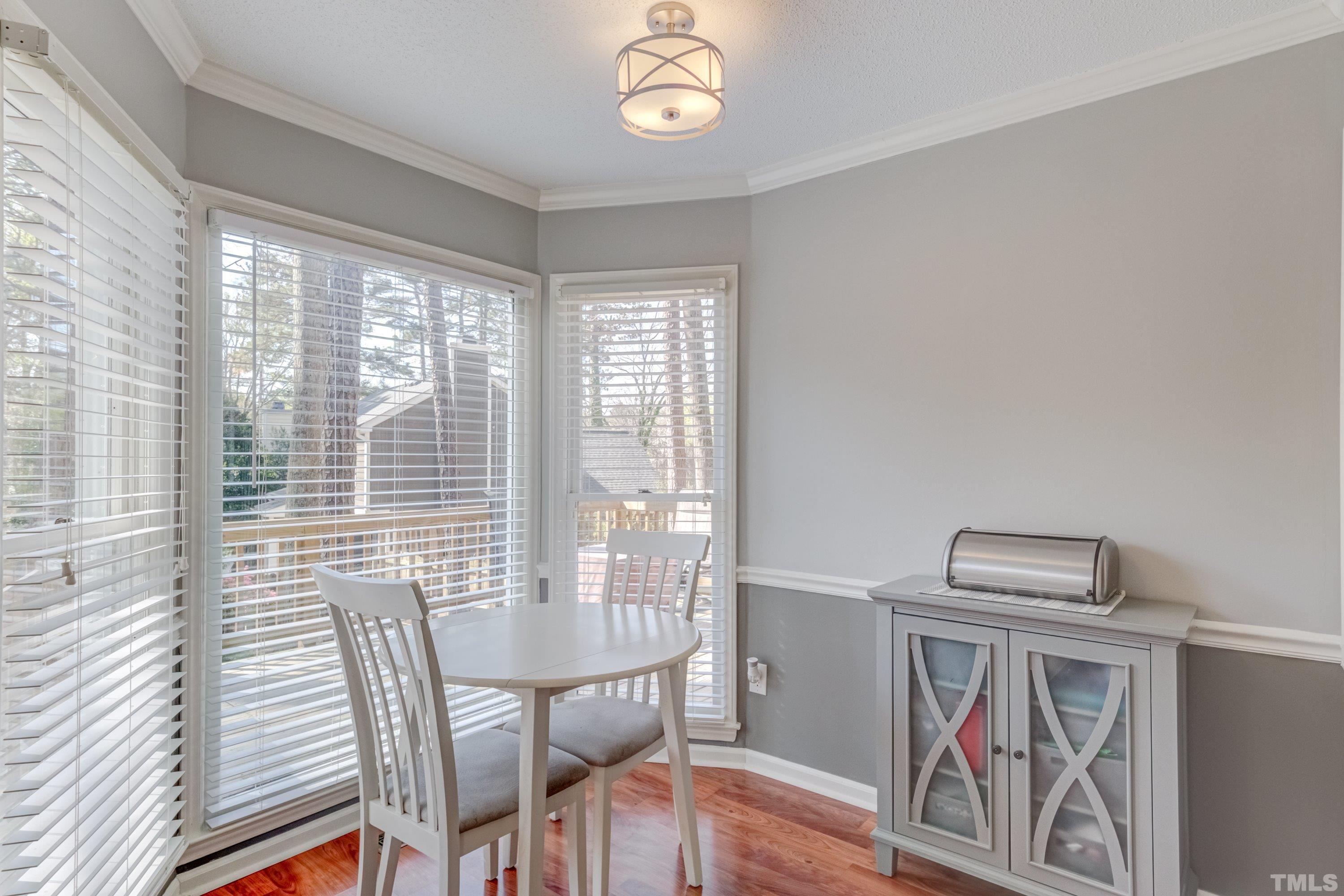 105 McIntire Lane Cary, NC 27513 - Photo 17 of 32 a view of a dining room with furniture wooden floor and a carpet