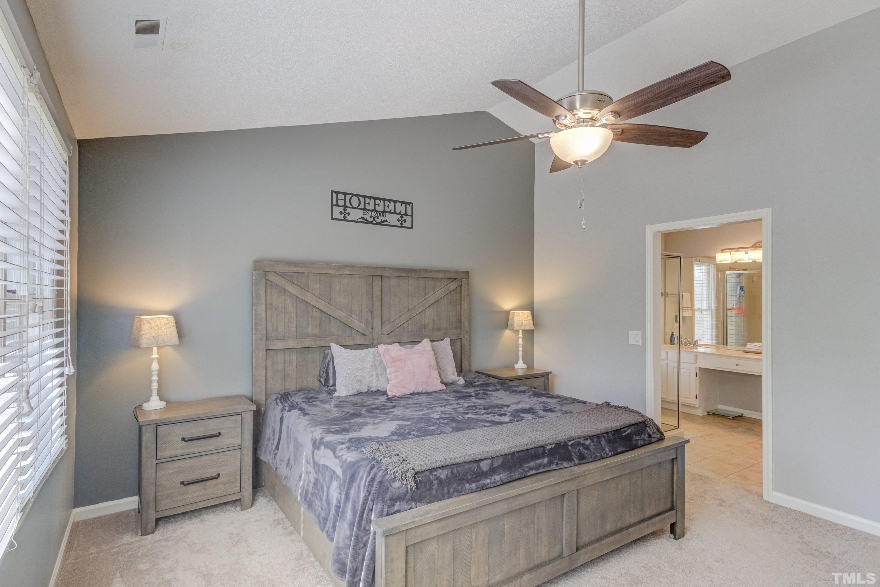 105 McIntire Lane Cary, NC 27513 - Photo 19 of 32 a bedroom with a bed and a chandelier