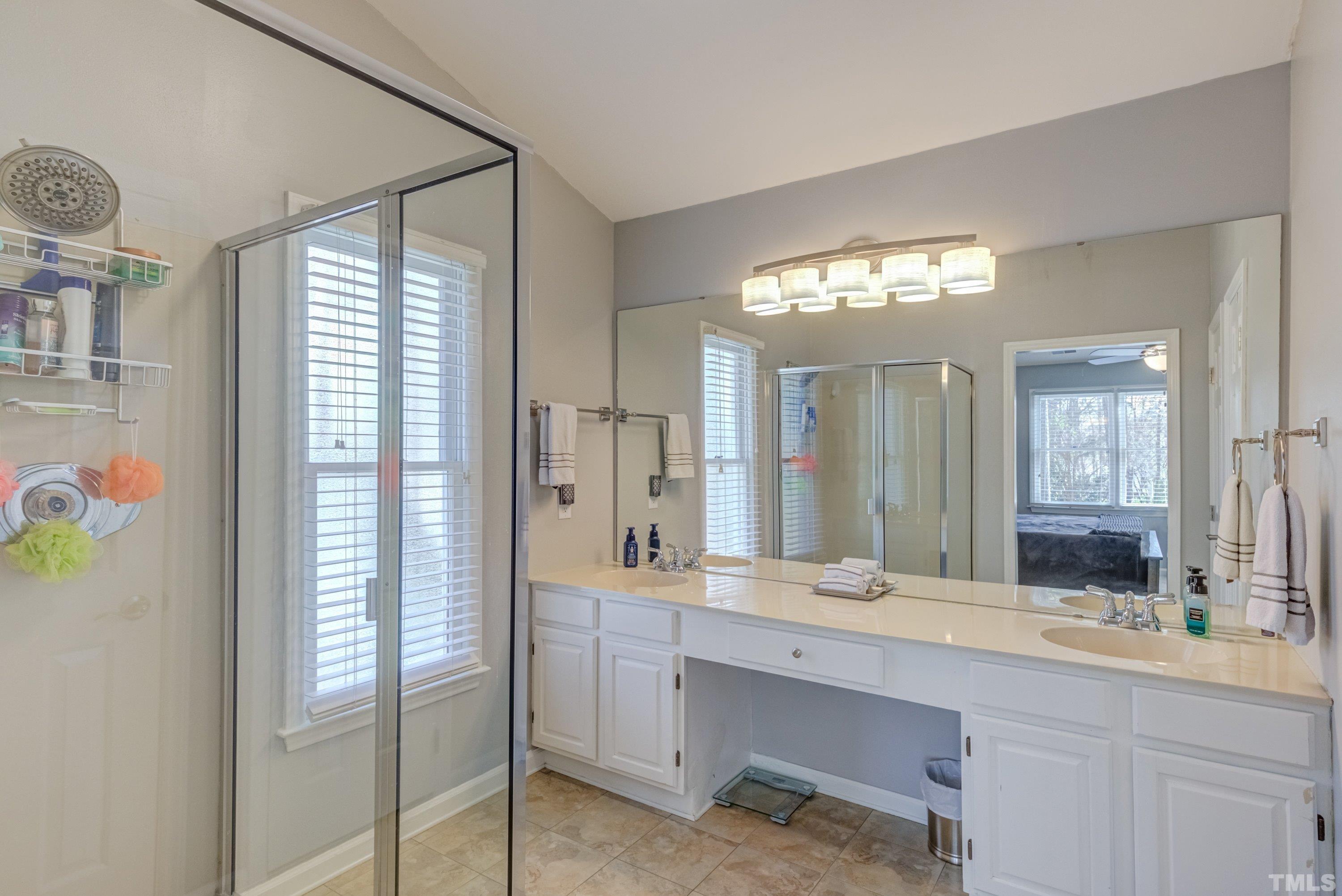 105 McIntire Lane Cary, NC 27513 - Photo 20 of 32 a bathroom with a double vanity sink and a mirror