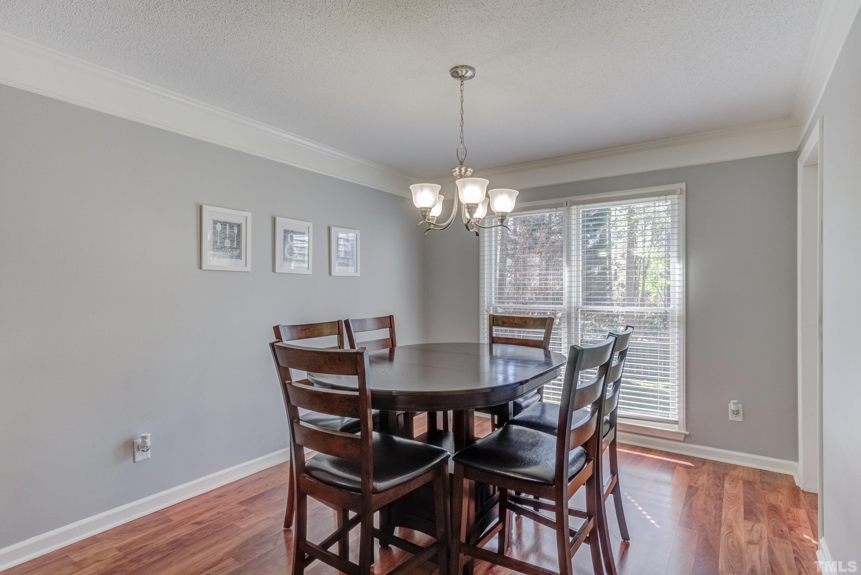 105 McIntire Lane Cary, NC 27513 - Photo 4 of 32 a view of a dining room with furniture window and wooden floor