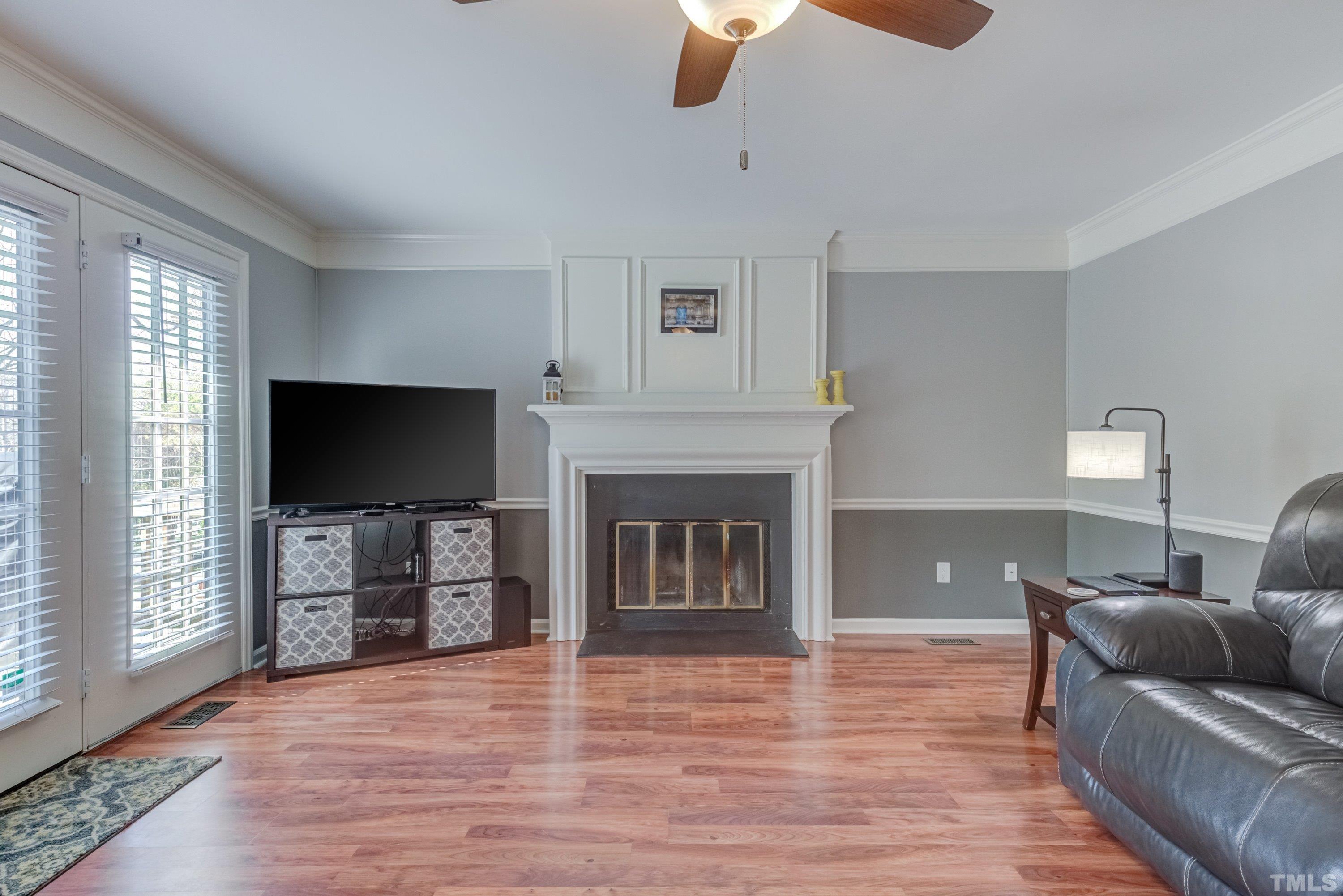 105 McIntire Lane Cary, NC 27513 - Photo 10 of 32 a living room with furniture a flat screen tv and a fireplace
