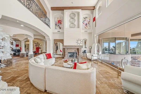 a living room with fireplace furniture and a kitchen view