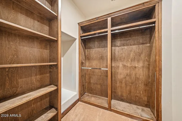 a bathroom with a granite countertop sink a mirror a bathtub and shower