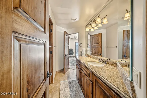 a bedroom with furniture and a chandelier