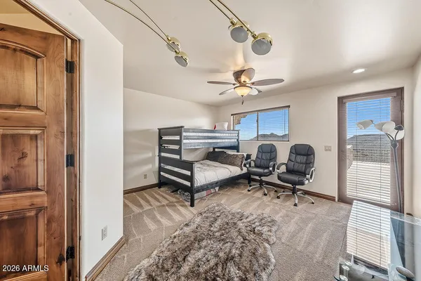 a spacious bedroom with a bed and a chandelier