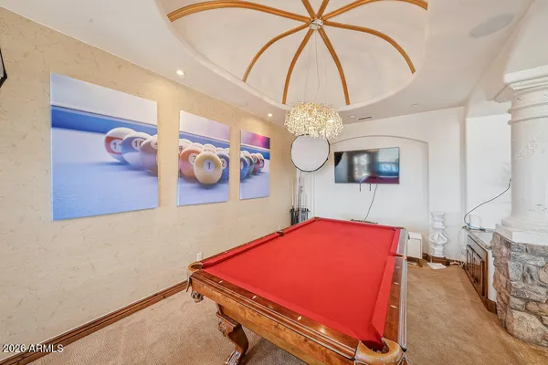a living room with furniture ceiling fan and a large window