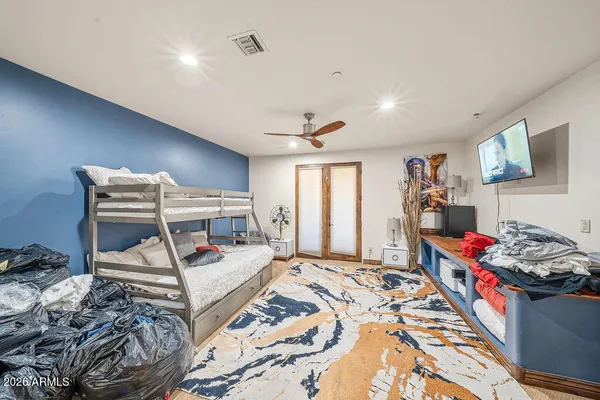 a bedroom with furniture and a large window