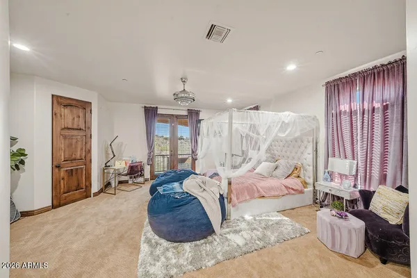 a bedroom with furniture and a flat screen tv