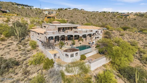 an aerial view of residential houses with outdoor space and trees