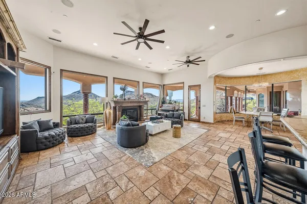 a living room with furniture a large window and a table