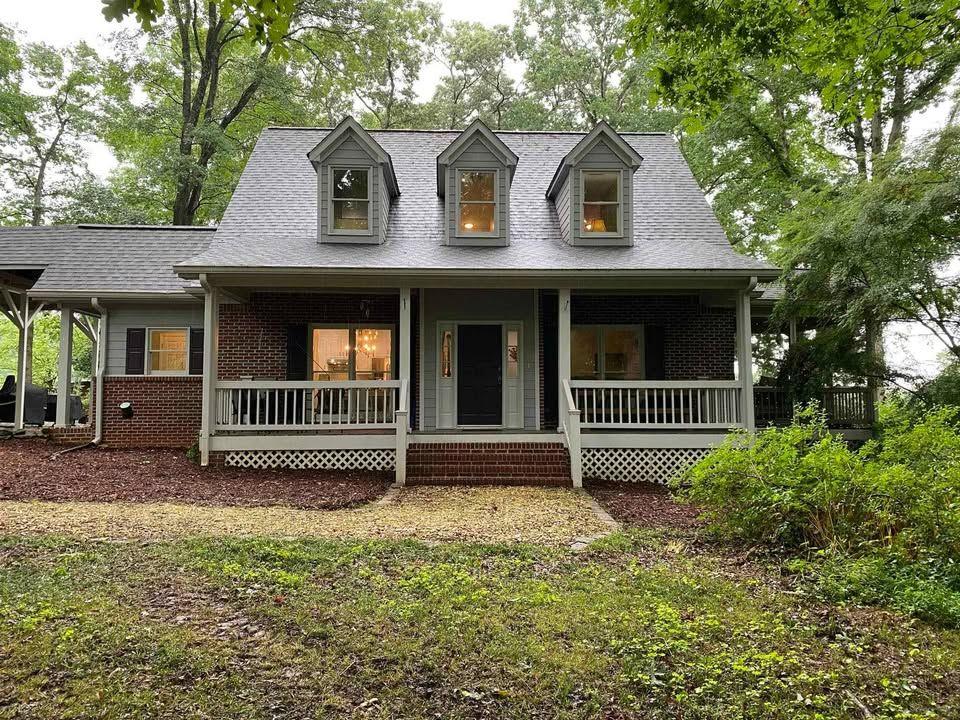 a front view of a house with a garden