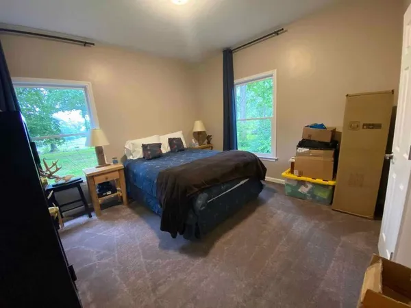 a bed sitting in a bedroom next to a window