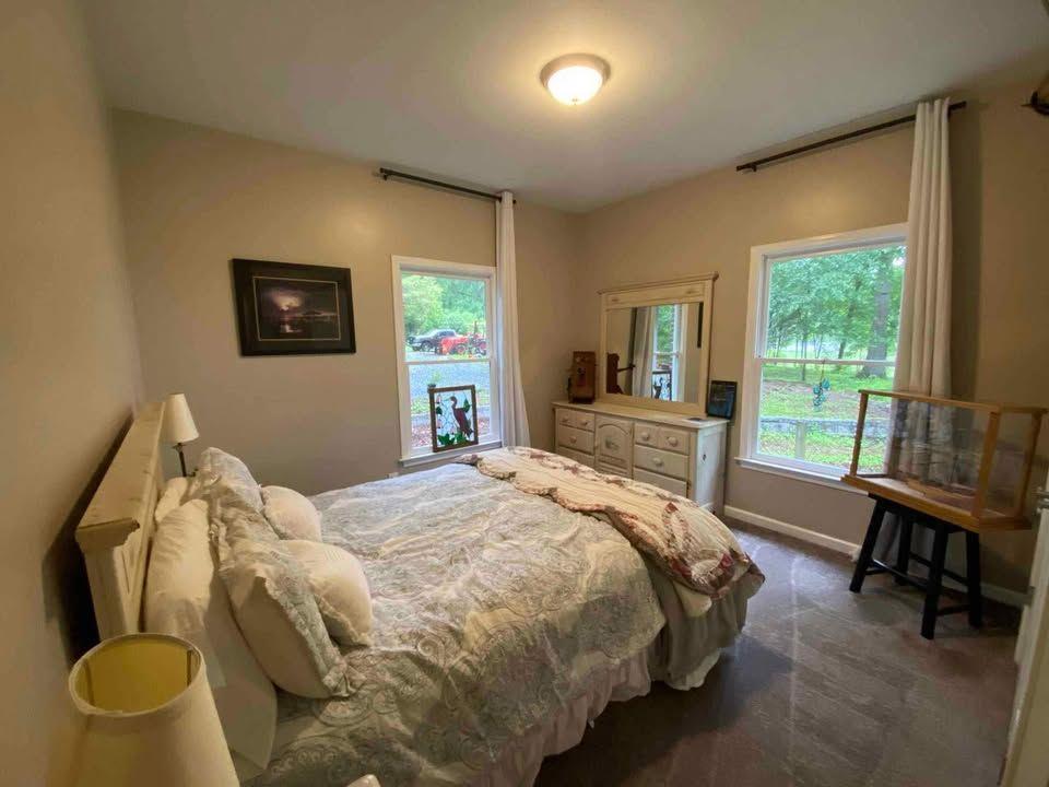 4005 South Apple Valley Road Commerce, GA 30529 - Photo 16 of 17 a bed sitting in a bedroom next to a window