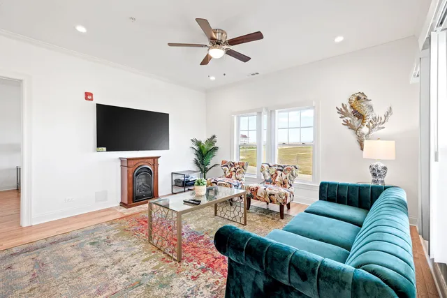 a living room with furniture a fireplace and a flat screen tv