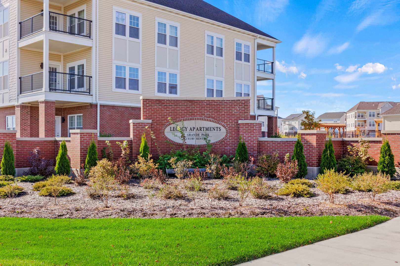 12829 Blue Spruce Drive, Unit 303 Plainfield, IL 60585 - Photo 10 of 11 a view of a building with a garden and pathway