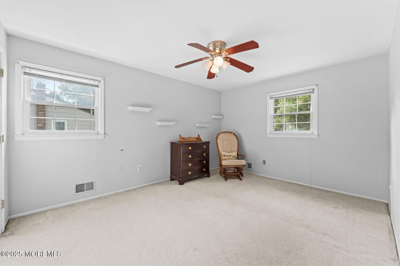 27 Farm Tree Road Manalapan, NJ 07726 - Photo 29 of 44 an empty room with windows and fan