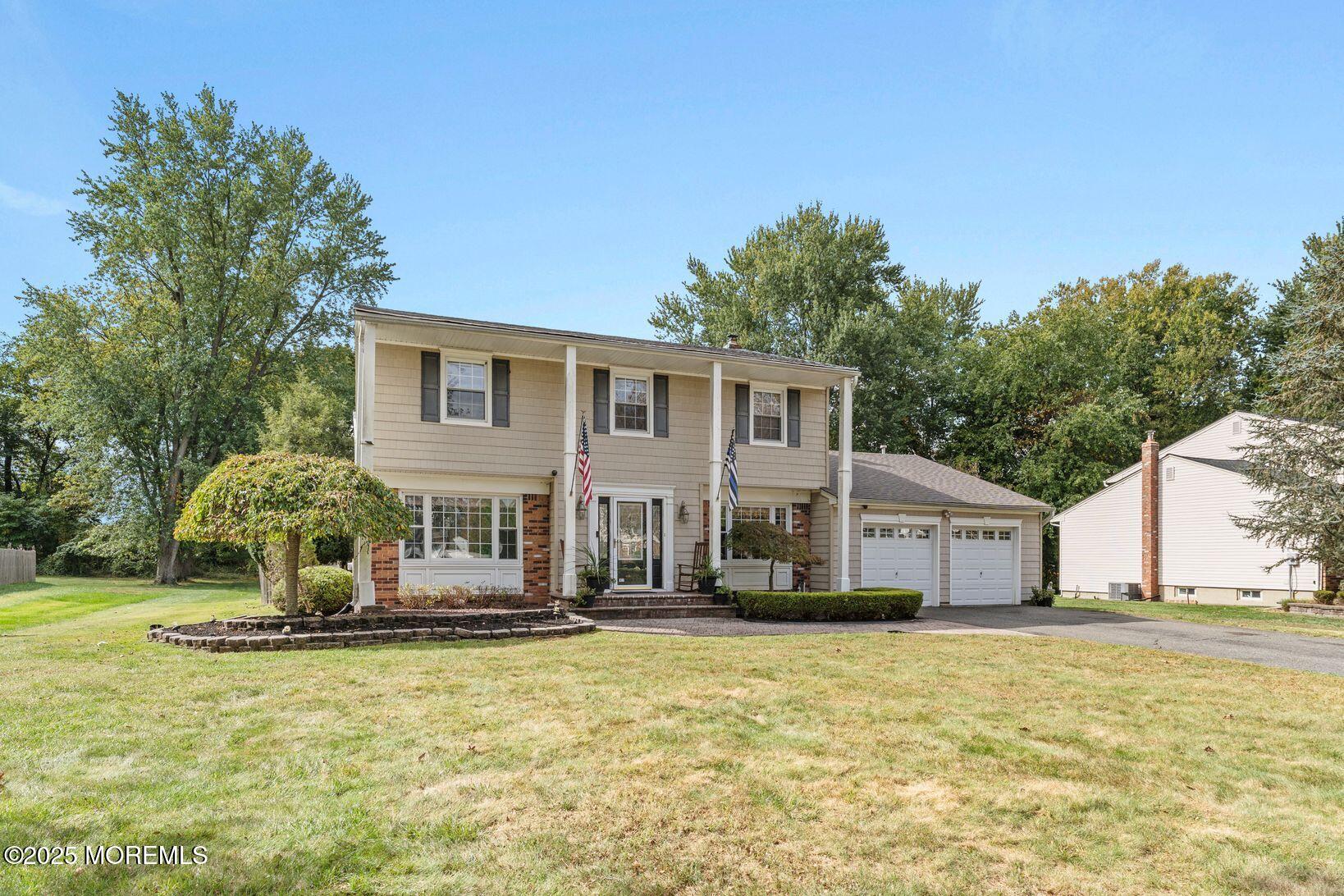 27 Farm Tree Road Manalapan, NJ 07726 - Photo 3 of 44 a front view of a house with a yard