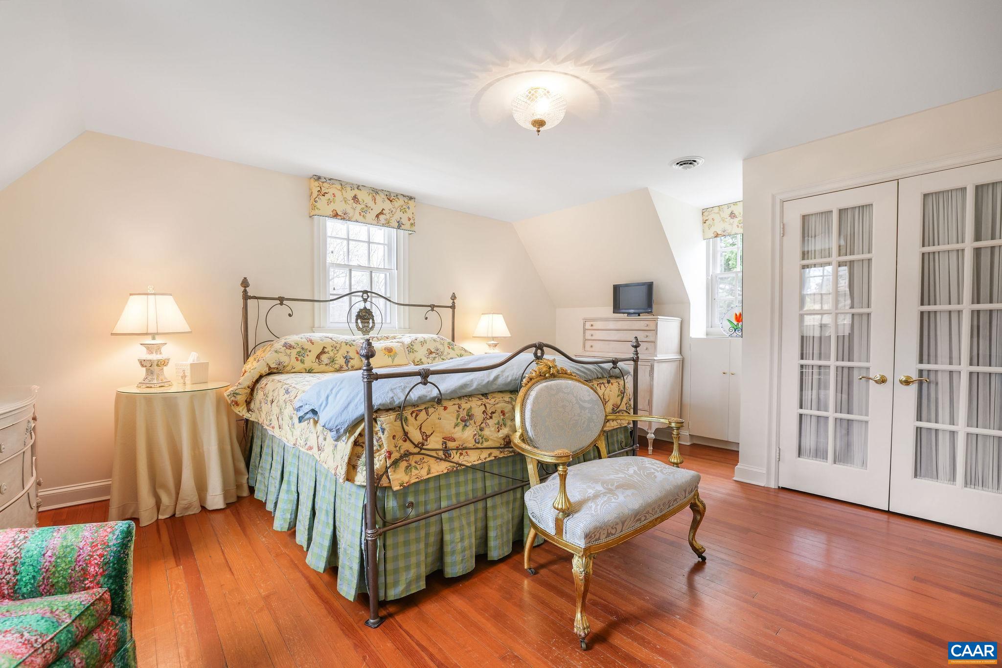 1335 Hilltop Road Charlottesville, VA 22903 - Photo 17 of 46 a bedroom with a bed and wooden floor