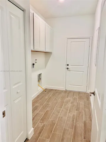 a view of an empty room with closet and a window