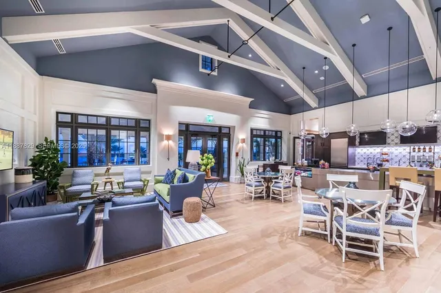 a living room with lots of furniture and kitchen view