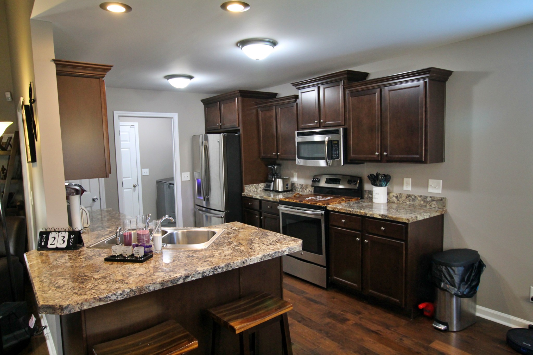 8005 New Chapel Road Springfield, TN 37172 - Photo 12 of 28 a kitchen with kitchen island granite countertop wooden cabinets and a refrigerator