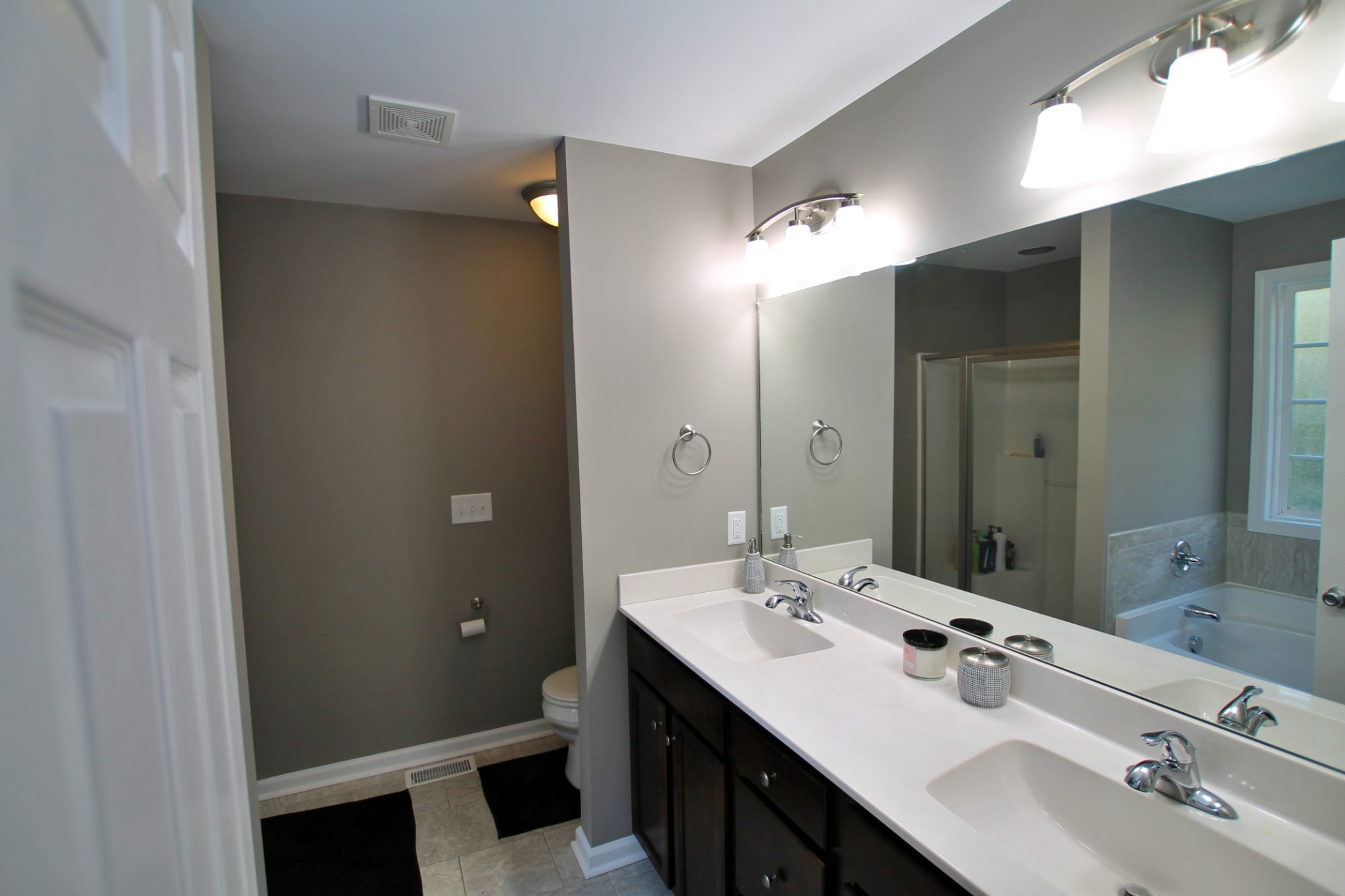 8005 New Chapel Road Springfield, TN 37172 - Photo 17 of 28 a bathroom with a double vanity sink and mirror
