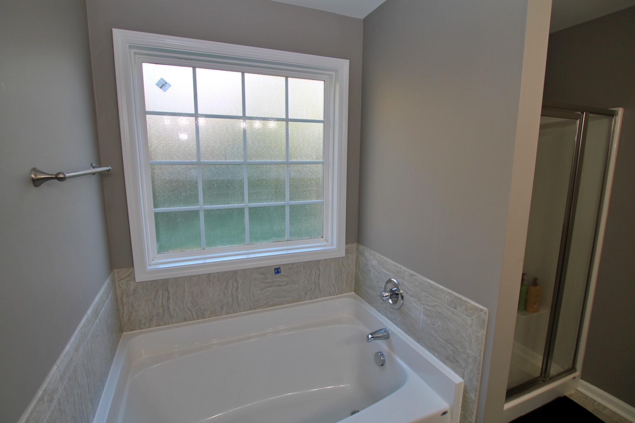 8005 New Chapel Road Springfield, TN 37172 - Photo 18 of 28 a white bath tub sitting next to a window