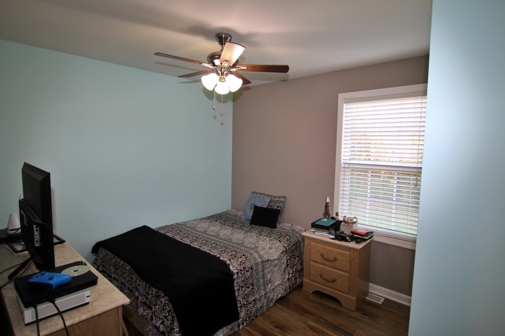 8005 New Chapel Road Springfield, TN 37172 - Photo 19 of 28 a bedroom with a bed and a chandelier