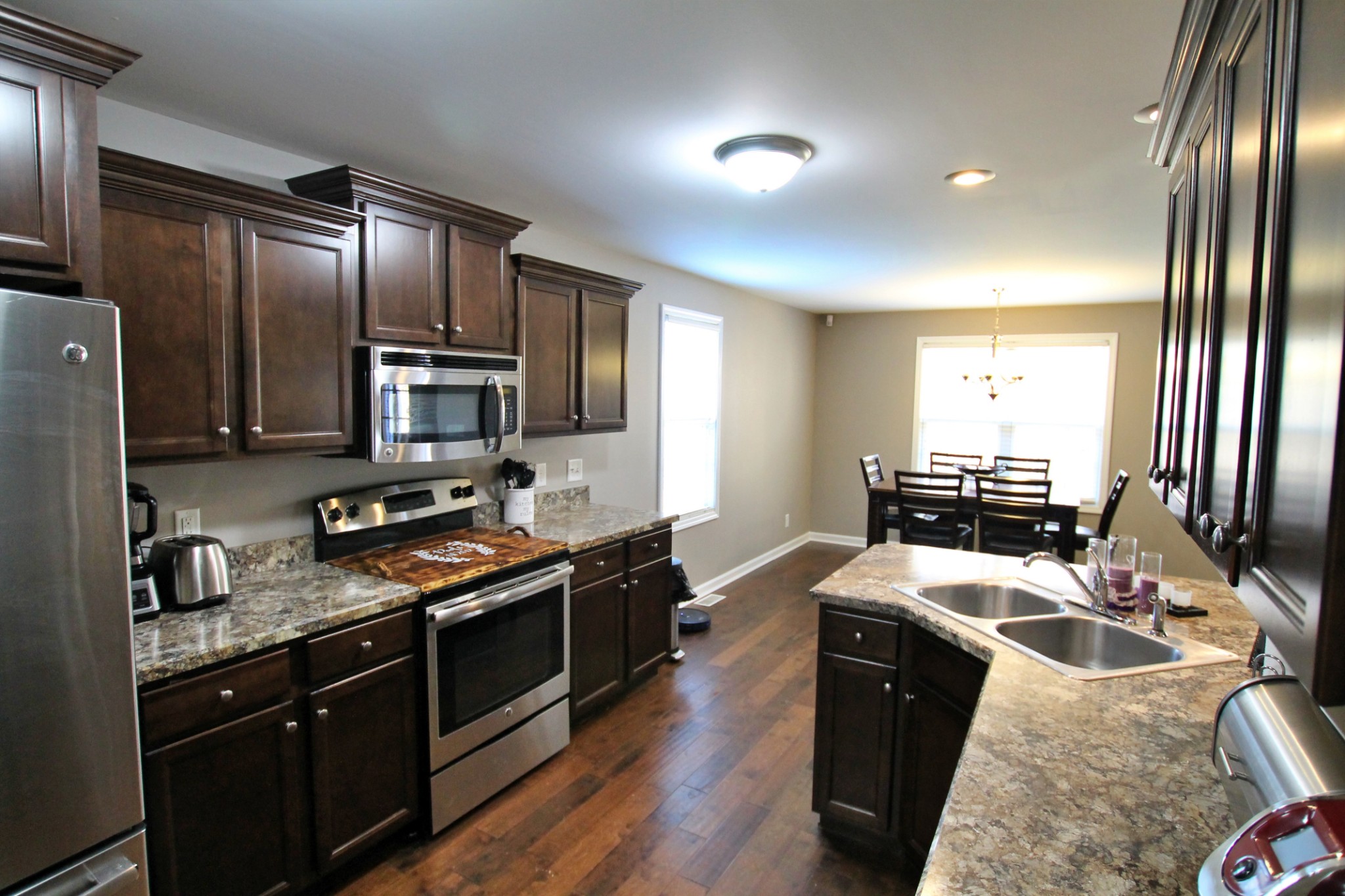 8005 New Chapel Road Springfield, TN 37172 - Photo 9 of 28 a kitchen with granite countertop stainless steel appliances and wooden cabinets