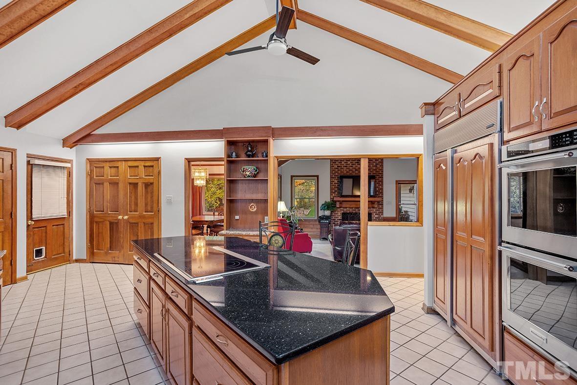105 Carriage Trail Raleigh, NC 27614 - Photo 11 of 32 a kitchen with granite countertop a sink and a refrigerator