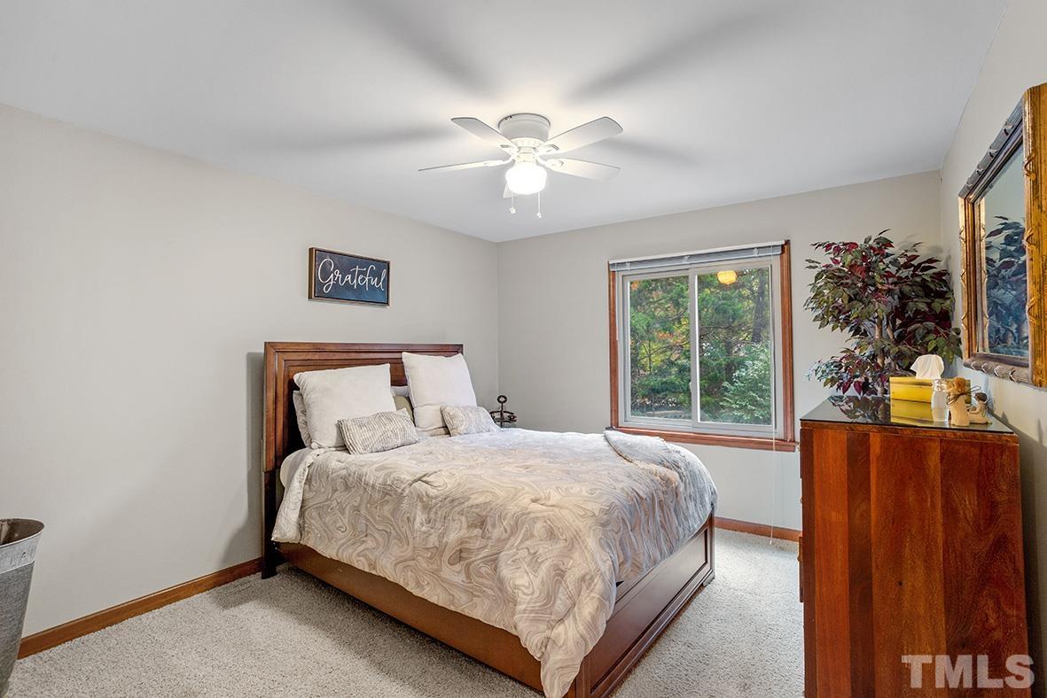 105 Carriage Trail Raleigh, NC 27614 - Photo 18 of 32 a bedroom with a bed and a large window