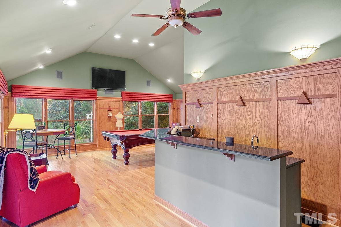 105 Carriage Trail Raleigh, NC 27614 - Photo 21 of 32 a living room with furniture a flat screen tv and a large window