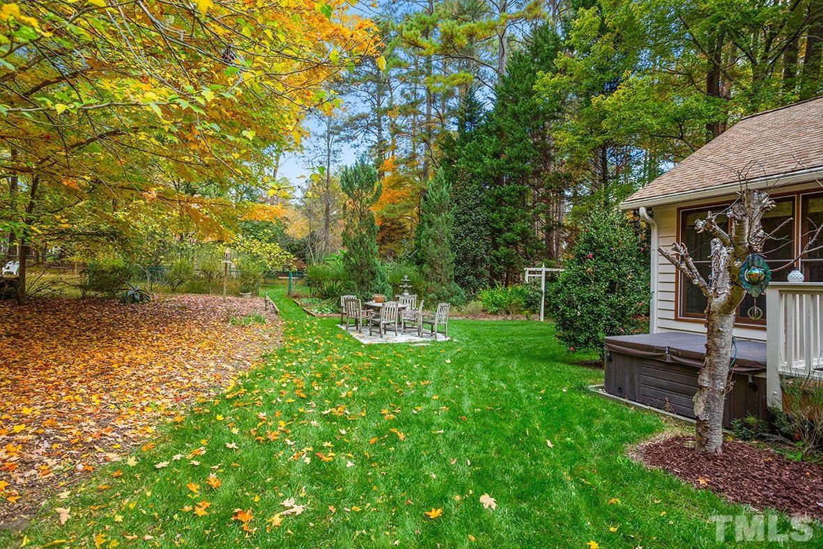 105 Carriage Trail Raleigh, NC 27614 - Photo 26 of 32 a view of backyard with table and chairs and potted plants