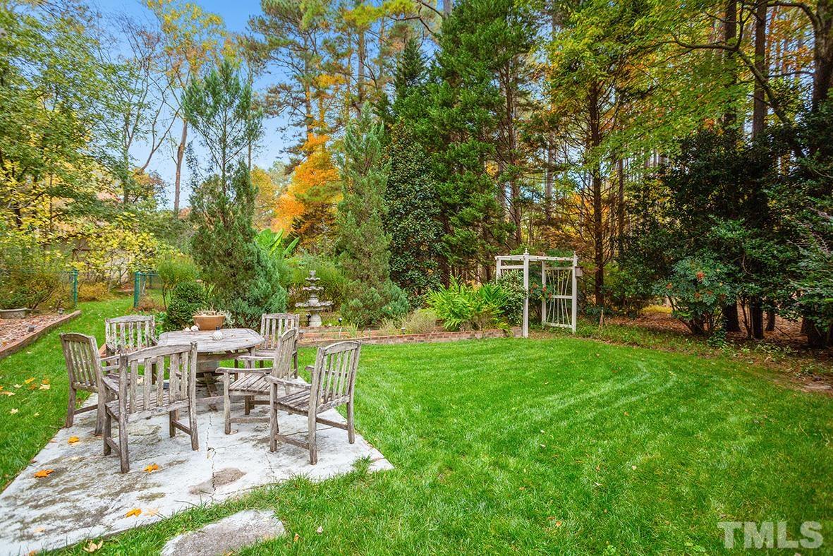 105 Carriage Trail Raleigh, NC 27614 - Photo 27 of 32 a view of a table and chairs in the garden