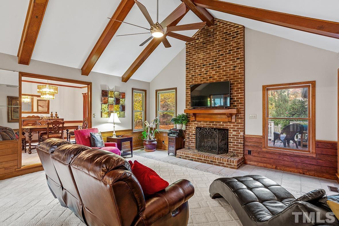 105 Carriage Trail Raleigh, NC 27614 - Photo 6 of 32 a living room with furniture a fireplace and a floor to ceiling window